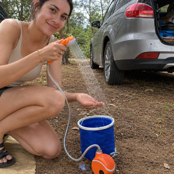 Family using AquaTrail portable shower while camping