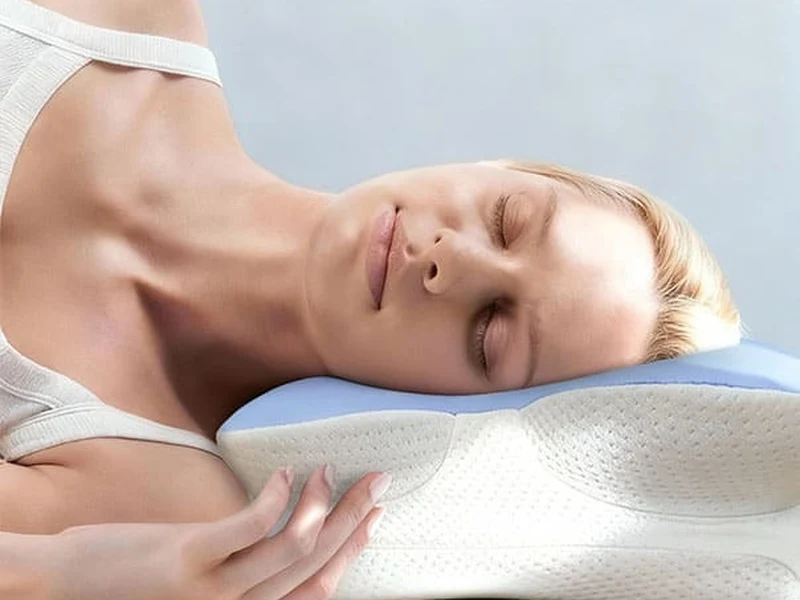 Person sleeping comfortably on a contoured ergonomic pillow