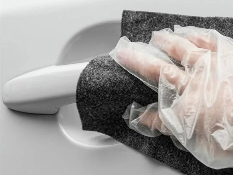 Applying a scratch remover cloth to a car panel